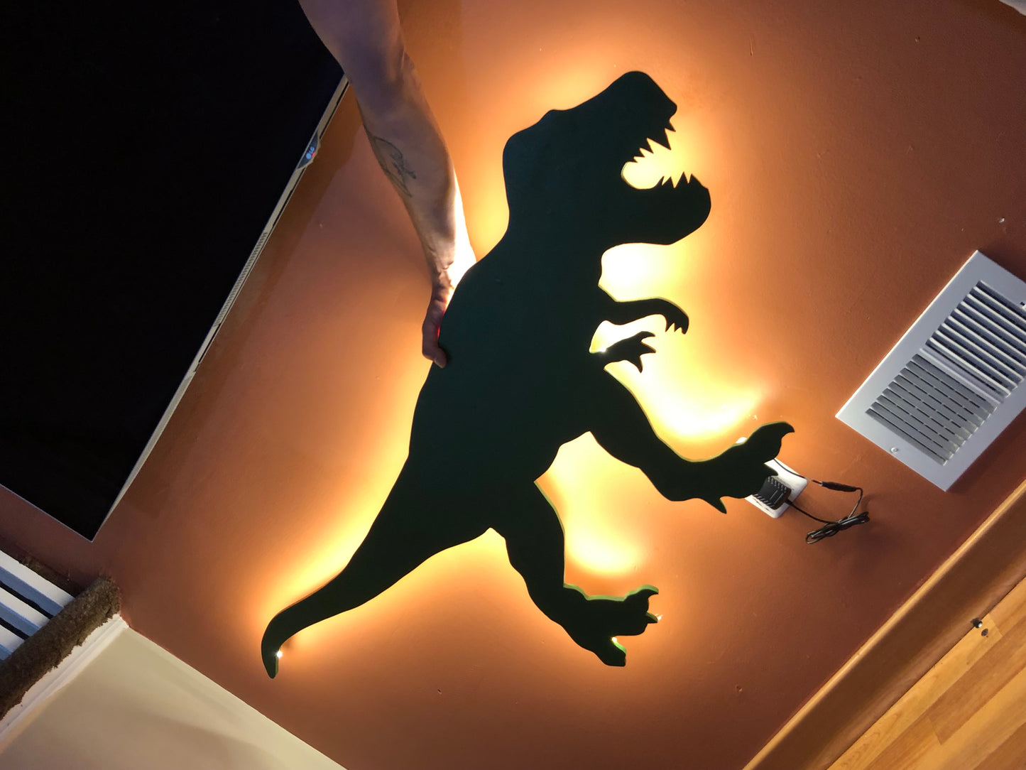 silhouette of a t-rex dinosaur with led lighting