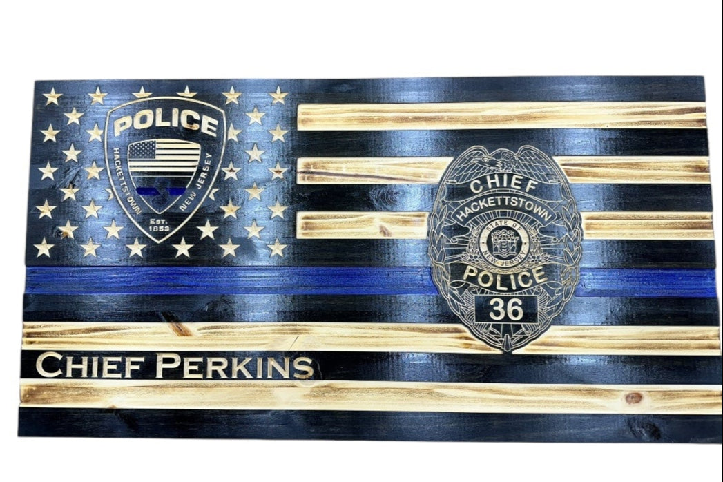 thin blue line american wooden flag with an engraved badge in the stars union and on the stripes with personalization