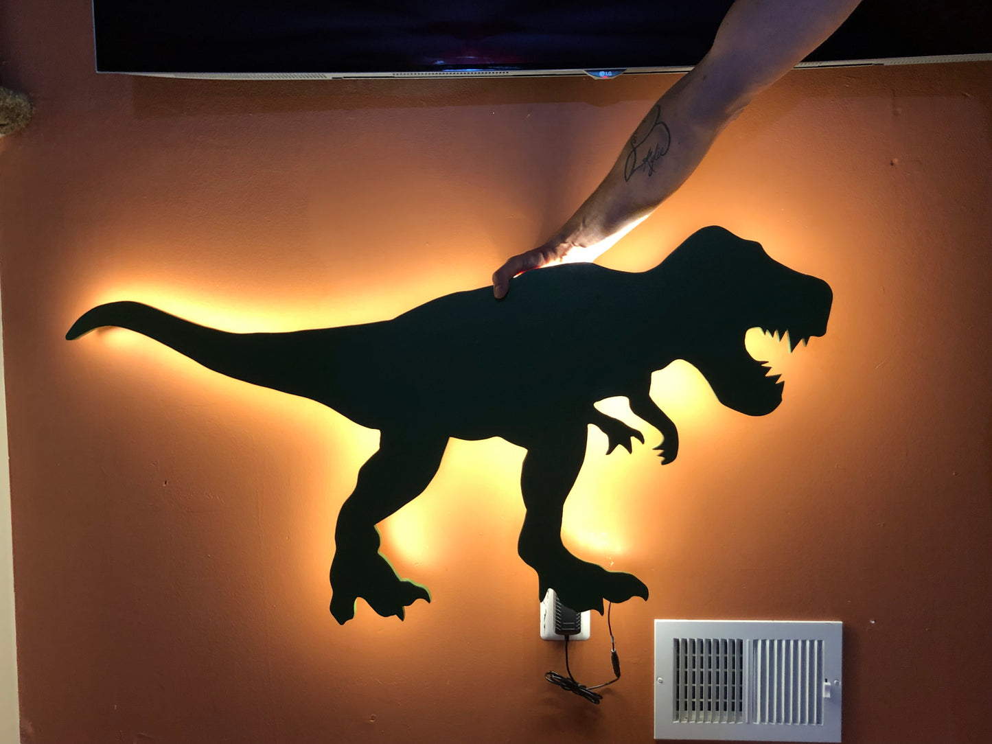 silhouette of a t-rex dinosaur with led lighting