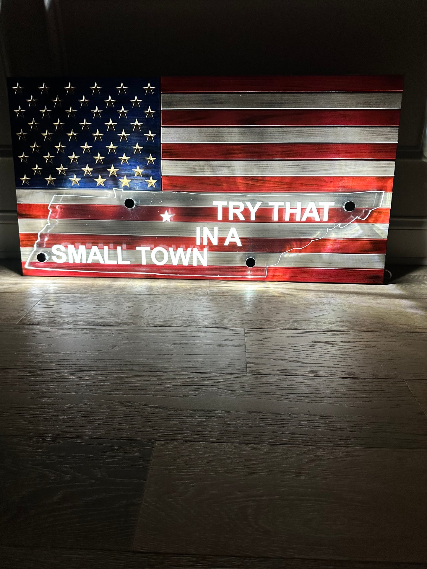 wooden american flag with acrylic cut out of a state and back lit with led lights with try that in the small town writing