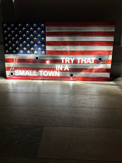 wooden american flag with acrylic cut out of a state and back lit with led lights with try that in the small town writing