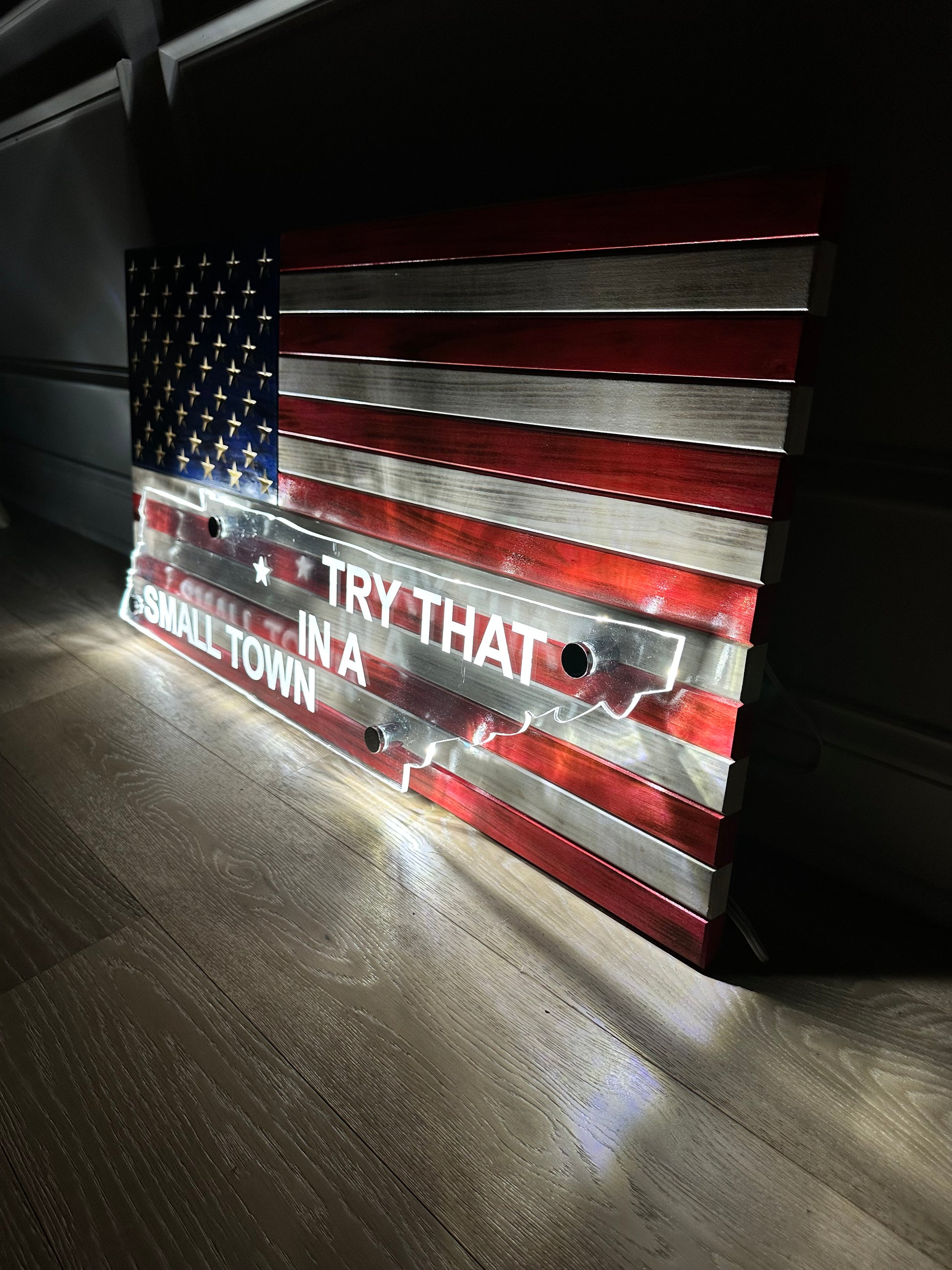 wooden american flag with acrylic cut out of a state and back lit with led lights