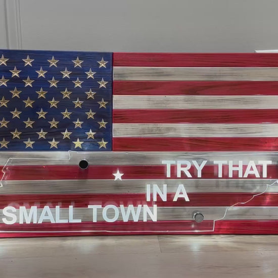 video of wooden american flag with acrylic cut out of a state and back lit with led lights